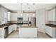 Kitchen featuring granite countertops, stainless steel appliances, an island, and white cabinetry at 14040 Helsby St, Orlando, FL 32832