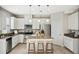 Bright kitchen with granite countertops, stainless steel appliances, island with seating, and white cabinetry at 14040 Helsby St, Orlando, FL 32832