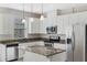 Kitchen with an island, granite counters, stainless steel appliances, and white cabinets at 14040 Helsby St, Orlando, FL 32832