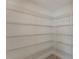 Walk-in pantry with multiple rows of metal shelving for optimal storage and organization in the home at 14040 Helsby St, Orlando, FL 32832