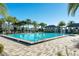 Enjoy this pristine community pool, surrounded by beautiful pavers, lush landscaping, and private changing cabanas at 14040 Helsby St, Orlando, FL 32832