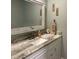 Bathroom featuring a white vanity with a marble countertop and decorative wall art at 1500 Markham Woods Rd, Longwood, FL 32779