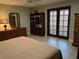Cozy bedroom with french doors, plenty of closet space, and neutral decor at 1500 Markham Woods Rd, Longwood, FL 32779