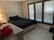 Bedroom featuring neutral decor, a window, and a tile floor at 1500 Markham Woods Rd, Longwood, FL 32779