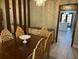 Dining room featuring wood floors, decorative chairs, and a view into the kitchen at 1500 Markham Woods Rd, Longwood, FL 32779