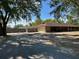 Ranch-style home featuring a long driveway and mature trees in a large front yard at 1500 Markham Woods Rd, Longwood, FL 32779