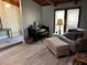 Neutral living area featuring a piano, cozy chair, and wood-look flooring at 1500 Markham Woods Rd, Longwood, FL 32779