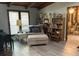 Cozy living room with a comfortable chair, bookshelves, and natural light from a window at 1500 Markham Woods Rd, Longwood, FL 32779