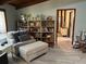 Comfortable living area with a cozy chair, ottoman, and built-in bookshelves at 1500 Markham Woods Rd, Longwood, FL 32779