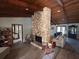 Spacious living room showcasing a striking stone fireplace and wood-look flooring at 1500 Markham Woods Rd, Longwood, FL 32779