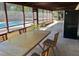 Spacious screened-in patio with a dining table and chairs, overlooking a pool and greenery at 1500 Markham Woods Rd, Longwood, FL 32779