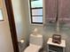 Neat toilet featuring neutral decor and a small window at 1500 Markham Woods Rd, Longwood, FL 32779