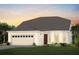 Inviting single-Gathering home featuring a two-car garage, manicured lawn, and beautiful landscaping at 15446 Orchard Garden St, Winter Garden, FL 34787