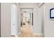 Inviting hallway with wood-look tile flooring leads to the open living spaces in this new home at 15446 Orchard Garden St, Winter Garden, FL 34787