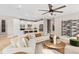 Open-concept living area with a comfortable sectional sofa, modern kitchen, and elegant dining space at 15446 Orchard Garden St, Winter Garden, FL 34787