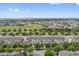 An aerial view of charming townhomes with manicured landscaping and picturesque green spaces on a sunny day at 15456 Blackbead St, Winter Garden, FL 34787