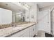 Bathroom featuring double sinks, granite countertops, and a glass-enclosed shower at 15456 Blackbead St, Winter Garden, FL 34787
