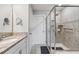 Bright bathroom featuring a glass enclosed shower, granite counters, and modern fixtures at 15456 Blackbead St, Winter Garden, FL 34787