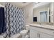 Bathroom featuring a granite vanity, sink, mirror, and modern fixtures at 15456 Blackbead St, Winter Garden, FL 34787