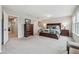 Spacious main bedroom with a dark wood furniture set and neutral carpeting at 15456 Blackbead St, Winter Garden, FL 34787