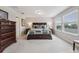 Bright bedroom featuring a luxurious king size bed, and windows with outdoor views at 15456 Blackbead St, Winter Garden, FL 34787