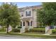 Charming townhouse with inviting front porch, manicured landscaping and vibrant trees at 15456 Blackbead St, Winter Garden, FL 34787