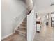 Hallway with carpeted stairs leading to the upper level of the home at 15456 Blackbead St, Winter Garden, FL 34787