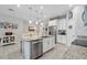 Well-lit kitchen with granite island, stainless steel appliances and modern fixtures at 15456 Blackbead St, Winter Garden, FL 34787
