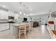 Open-concept kitchen with granite island, stainless appliances and seamless flow to living area at 15456 Blackbead St, Winter Garden, FL 34787