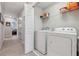 Conveniently located laundry room with shelving and full-size washer and dryer at 15456 Blackbead St, Winter Garden, FL 34787