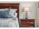 Comfortable bedroom with a decorative headboard, nightstand, and bedside lamp at 15456 Blackbead St, Winter Garden, FL 34787