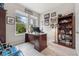 Bright home office space with a large window, desk, and bookshelves at 15456 Blackbead St, Winter Garden, FL 34787