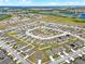 Bird's-eye view of a neighborhood highlighting well-maintained properties, complemented by water features and open fields at 1579 Swan Lake Cir, Dundee, FL 33838