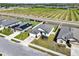 An aerial view of a lovely neighborhood with neat lawns, sidewalks, and grove views at 1579 Swan Lake Cir, Dundee, FL 33838