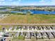 Scenic aerial view combining residential living with natural elements, featuring rows of trees and tranquil waters nearby at 1579 Swan Lake Cir, Dundee, FL 33838
