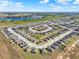 Sweeping aerial perspective of a residential development, showcasing uniform housing layouts and surrounding agricultural land at 1579 Swan Lake Cir, Dundee, FL 33838