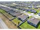 Aerial view of a neighborhood showing similar homes, street, and surrounding landscapes at 1579 Swan Lake Cir, Dundee, FL 33838