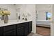 Bathroom vanity with white countertop and a door leading to a bedroom with a ceiling fan at 1579 Swan Lake Cir, Dundee, FL 33838