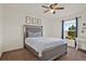Bright bedroom with ample natural light, a ceiling fan, and a stylish, comfortable bed at 1579 Swan Lake Cir, Dundee, FL 33838