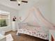 Adorable bedroom with a colorful canopy bed and a bright window at 1579 Swan Lake Cir, Dundee, FL 33838