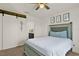 Comfortable bedroom features a modern sliding barn door and ensuite bathroom at 1579 Swan Lake Cir, Dundee, FL 33838