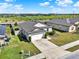 Charming single-Gathering home featuring a well-manicured lawn, attached garage, and grove views at 1579 Swan Lake Cir, Dundee, FL 33838