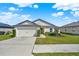 Charming single-story home with a well-manicured lawn and two car garage at 1579 Swan Lake Cir, Dundee, FL 33838