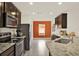 Stylish kitchen featuring dark wood cabinetry and stainless steel appliances at 1579 Swan Lake Cir, Dundee, FL 33838