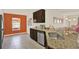 Well-lit kitchen featuring granite counters, stainless appliances, and tiled flooring at 1579 Swan Lake Cir, Dundee, FL 33838