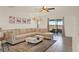 Bright living room with sliding door, open floor plan, and ceiling fan at 1579 Swan Lake Cir, Dundee, FL 33838