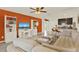 Open-concept living room featuring neutral tones, an accent wall and breakfast bar at 1579 Swan Lake Cir, Dundee, FL 33838