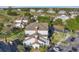 Overhead perspective showing a community with well-maintained landscaping, golf course, and a convenient parking lot at 1598 Heritage Crossing Ct # 302, Reunion, FL 34747