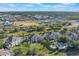 Aerial view of the property showcasing the community's layout, pool, landscaping, and surrounding neighborhood at 1598 Heritage Crossing Ct # 302, Reunion, FL 34747