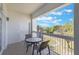 Cozy balcony with seating offers a relaxing outdoor space with a view of the landscaped surroundings at 1598 Heritage Crossing Ct # 302, Reunion, FL 34747